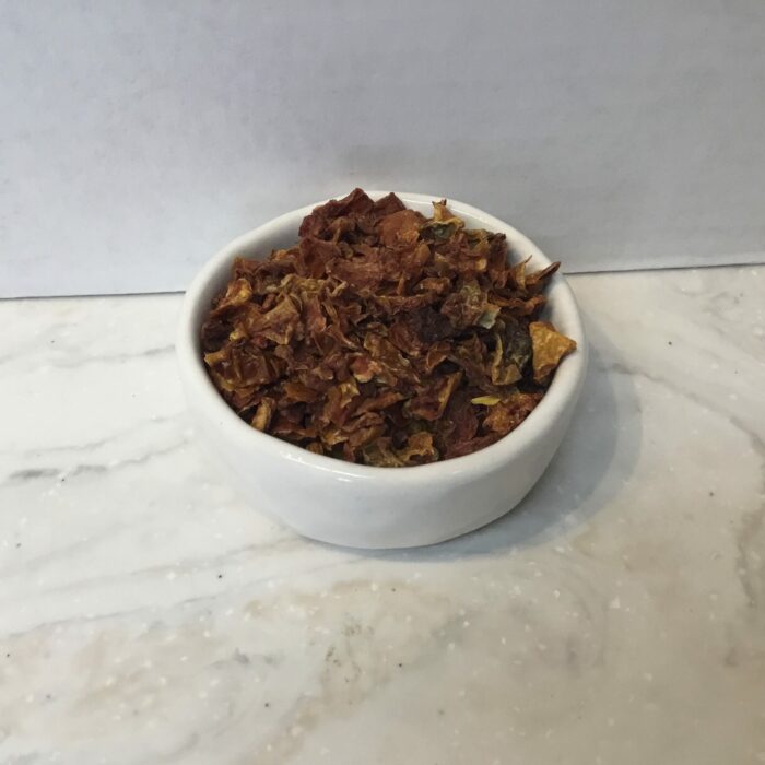 Dried tomato flakes are dehydrated pieces of tomato. This preservation method intensifies the flavor of the tomatoes and extends their shelf life.