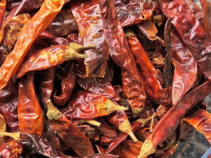 Chili peppers are a type of spicy pepper that come in various shapes, sizes, and levels of heat. They are often used in cooking to add a spicy kick to dishes.