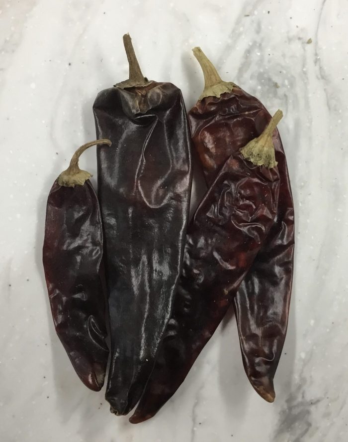 Dried guajillo peppers are a type of chili pepper widely used in Mexican cuisine that have a moderately spicy flavor, with fruity and tangy undertones.