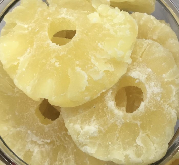 Candied pineapple, is made by coating pineapple pieces with a sugar syrup. This process preserves the fruit and gives it a sweet, chewy texture.